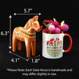 A Gammelröd Old Red Swedish Dala Horse—hand-carved and 16 cm (6 in) tall—is displayed with its dimensions beside a decorated mug filled with felt balls and flowers against a black background.