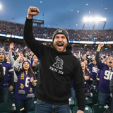A man in a black "Nordic Viking DNA Heritage" hoodie cheers with fellow fans in purple jerseys at a football stadium, all enthusiastically celebrating their Nordic roots.