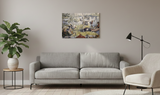 A living room with a gray sofa, beige armchair, potted plant, floor lamp, and the "Artwork: The Crayfish Season Opens Carl Larsson 1897 Print on Canvas" displayed on the light-colored wall.