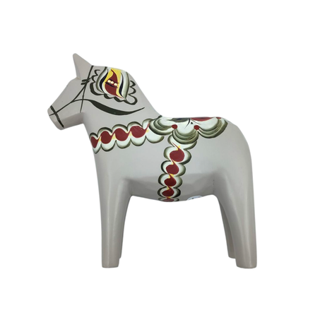 The Dala Horse: Anniversary Series Swedish Dala Horse Anders in gray is hand-carved and features red, yellow, and green kurbits patterns, standing gracefully in profile.