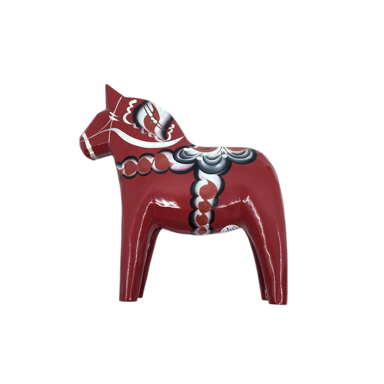 The Dala Horse: Anniversary Series Swedish Dala Horse Maria is a hand-carved masterpiece made from red wood with intricate decorative patterns, standing upright and facing left.