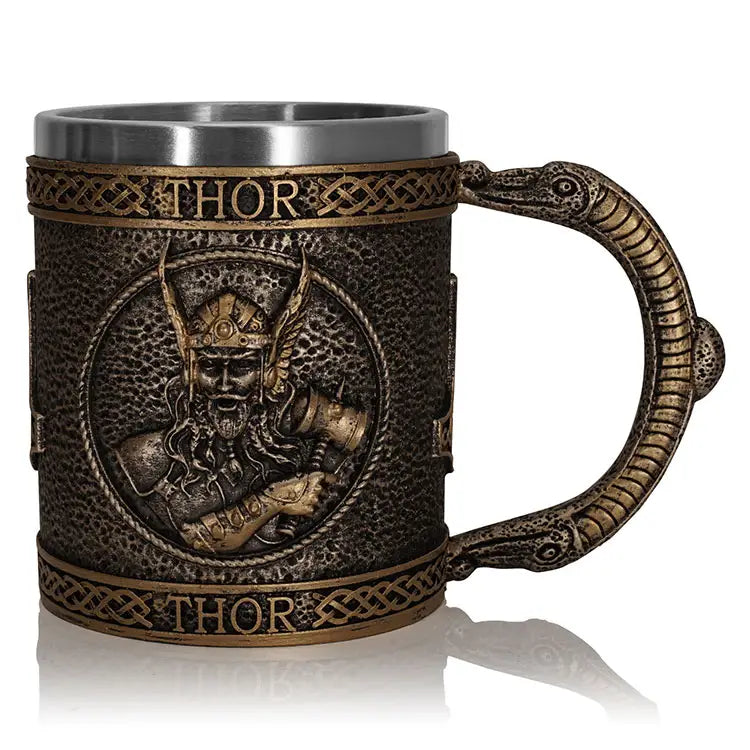 Introducing the Mug: Thor, God of Thunder & Lightning (15oz), a decorative masterpiece featuring a resin exterior adorned with an intricate relief of the Norse figure and the inscription THOR above and below. The detailed handle is designed to resemble a serpent, while the stainless steel interior ensures that your beverage stays hot.