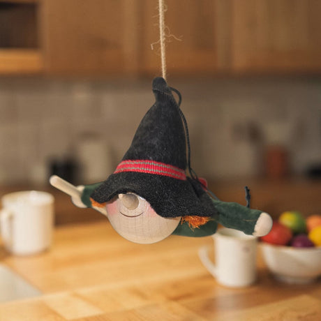 The Kitchen Witch Handcrafted Wood and Felt Figurine (4.5" long) adds a playful, Nordic-inspired charm to your kitchen decor as a whimsical household guardian.
