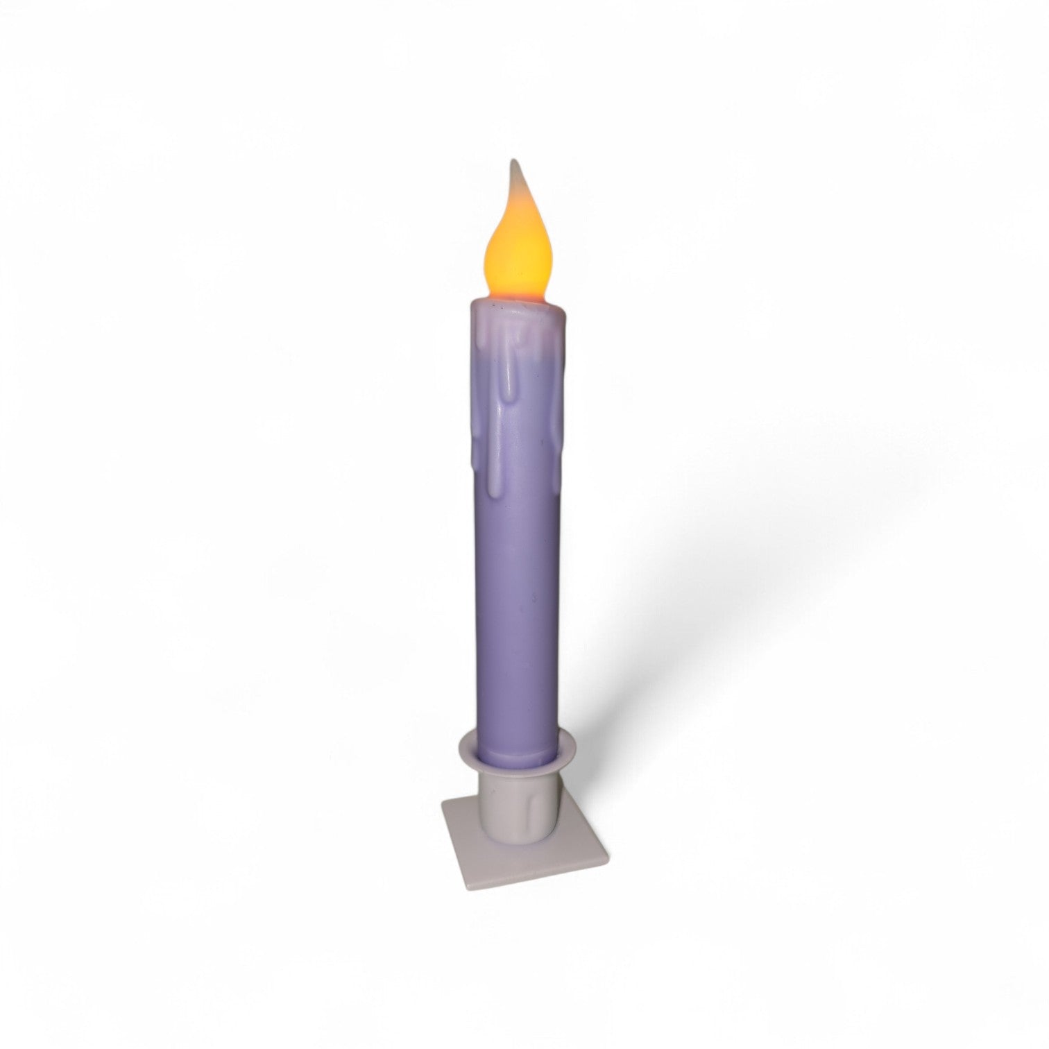 A purple Hand-Dipped Beeswax 7" Tapered LED Light Candle with a yellow flame sits in a white square holder against a plain white background.