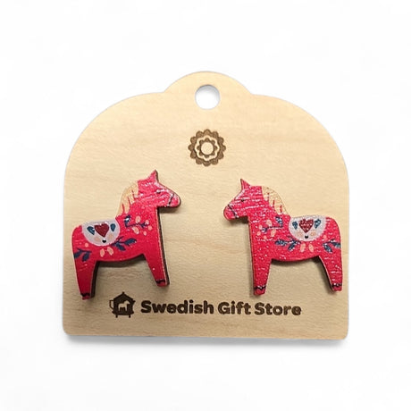 Red Dala Horse Stud Earrings with multi-colored Kurbits, celebrating Swedish heritage, are displayed on a card labeled Swedish Gift Store and evoke the charm of classic Nordic jewelry.
