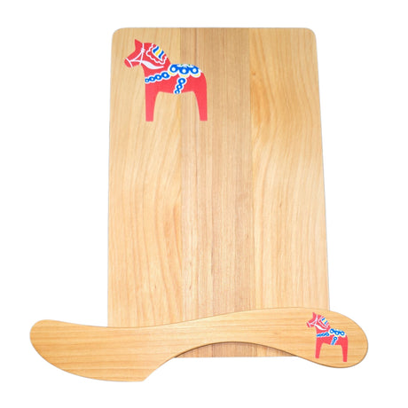 The Board & Spreader: Red Dala Horse Alder Sandwich Board and Spreader features eco-friendly wood, each piece adorned with a red Swedish Dala Horse with blue and white accents, shown on a white background.