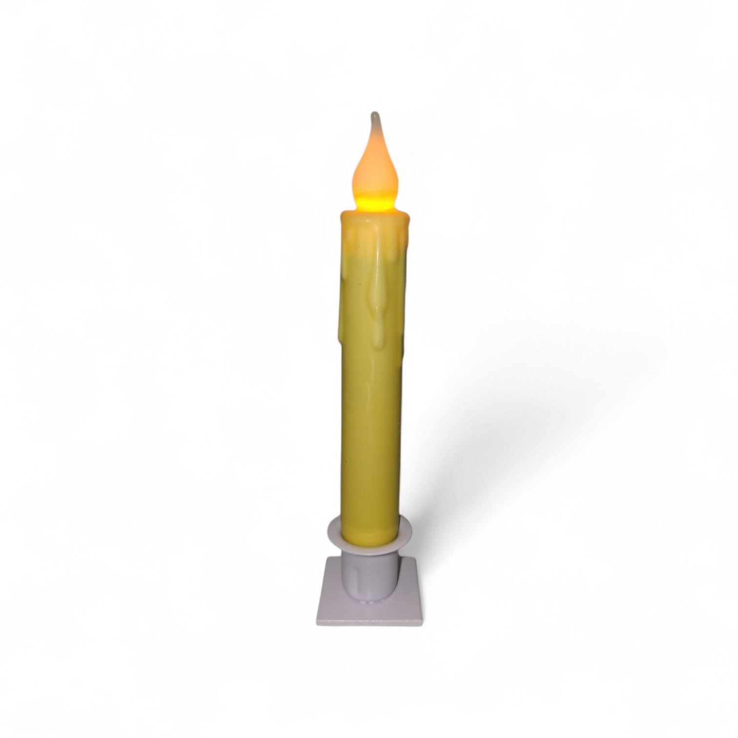 The Candle: Hand-Dipped Beeswax 7" Tapered LED Light is a battery-operated timer candle with a yellow flame-shaped bulb, realistic wax-like drips, and stands on a small white base against a plain background.