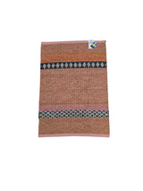 The Horredsmattan Forest Rust cotton/vinyl rug features brown, pink, and black geometric patterns and a small tag at the top right corner.
