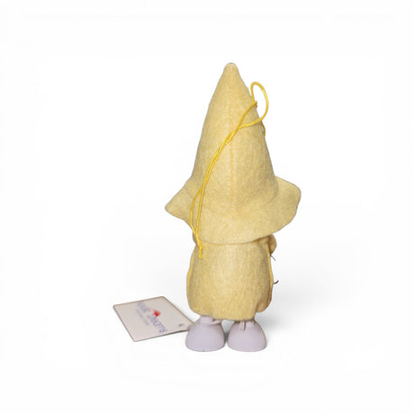 The Figurine: Scandinavian Tomte Girl in Yellow by Faire - Nordic Dreams is a handcrafted gnome plush holding a watering can, with a yellow hat and outfit, perfect for adding charm to Nordic home decor. Plain white background included.