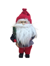 The Figurine: Santa with Glittering Tree is a handcrafted Swedish Santa with a red hat, bushy white beard, and red pants, holding a glittering green tree, set against a white background.