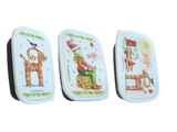 The Mini Christmas Box Container with Marie Stendahl designs features three rectangular boxes with white lids—a straw goat, a gnome, and festive greetings—for charming Swedish holiday décor.