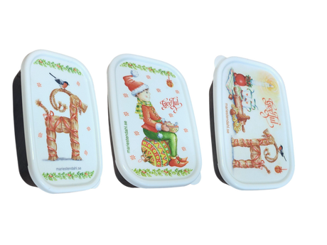 The Mini Christmas Box Container with Marie Stendahl designs features three rectangular boxes with white lids—a straw goat, a gnome, and festive greetings—for charming Swedish holiday décor.