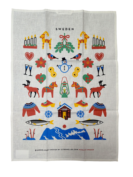 The Tea Towel: Swedish Winter Traditions—cotton/linen blend (50×70 cm)—features colorful Swedish folk motifs and “Sweden” at the top; a charming Scandinavian gift inspired by Sweden’s winter heritage.