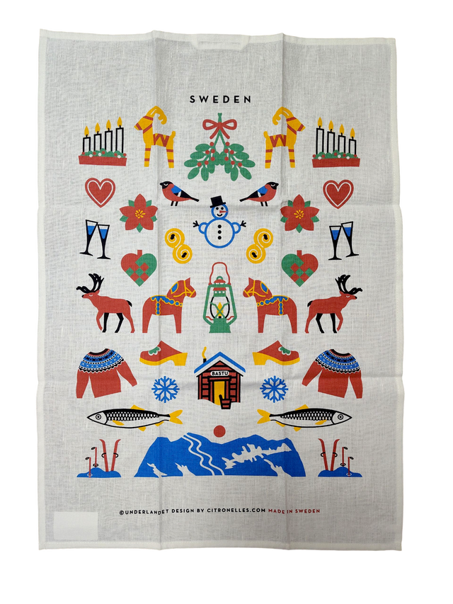 The Tea Towel: Swedish Winter Traditions—cotton/linen blend (50×70 cm)—features colorful Swedish folk motifs and “Sweden” at the top; a charming Scandinavian gift inspired by Sweden’s winter heritage.