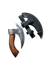 The Titan Nordic Raven Pizza Cutter, approx. 12" × 6", features Norse-inspired craftsmanship with an engraved metal blade, wooden handle, and comes with a black leather hand axe sheath with yellow stitching.