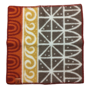 Wool Seat Pad: Uppsala Rust by Kerstin Landström features geometric and wave patterns in red, yellow, and gray. Made from OEKO-TEX certified lambswool for premium softness, it includes a leather tag in one corner.