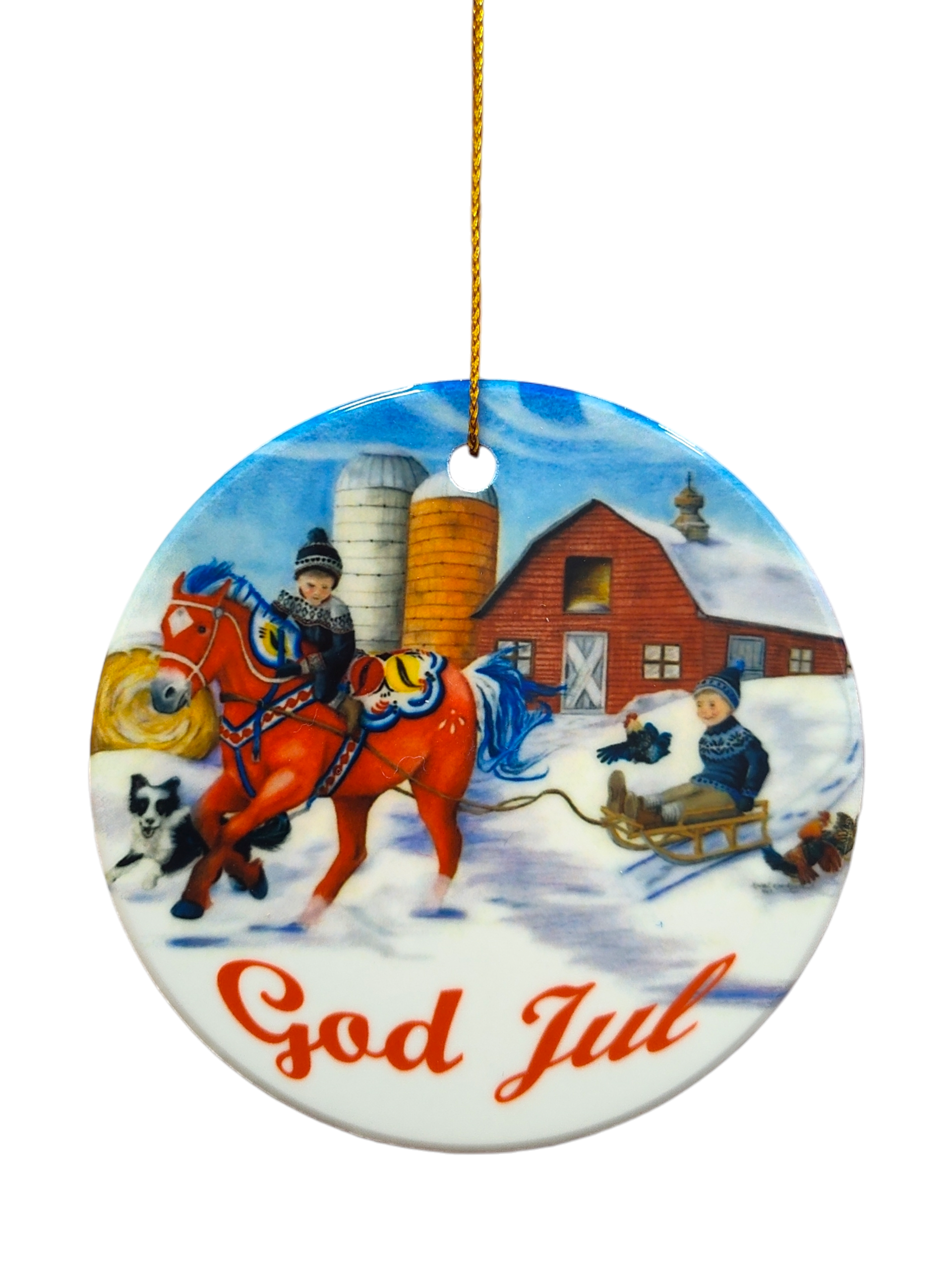 Ornament: God Jul Dala Horse Circle Ceramic Ornament features a snowy farm scene with a red Dala horse, two children (one riding, one on a sled), and a dog near a barn and silos, plus "God Jul" text.