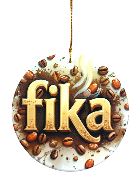 The Ornament: Fika Coffee Ceramic Ornament features “fika” in bold letters, coffee beans, and steam on a round ceramic piece with a gold string—perfect for celebrating Scandinavian coffee culture and enhancing your Nordic décor.