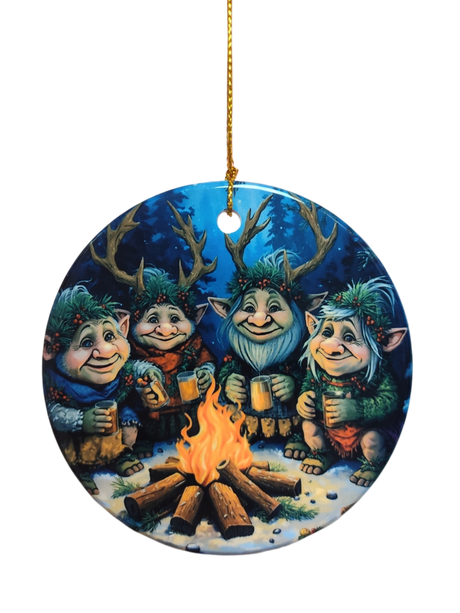The Ornament: Gnomes Around a Fire Ceramic Ornament features four cheerful, antlered trolls with mugs by a campfire in a snowy forest—an ideal holiday tree decoration.