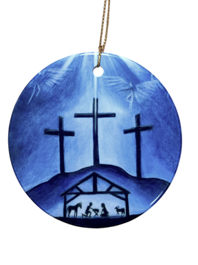 The Ornament: Blue Crosses Ceramic Ornament features three crosses on a hill above a nativity scene, set against a blue background and finished with a gold hanging string—a meaningful religious decoration for your Christmas tree.