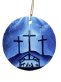 The Ornament: Blue Crosses Ceramic Ornament features three crosses on a hill above a nativity scene, set against a blue background and finished with a gold hanging string—a meaningful religious decoration for your Christmas tree.