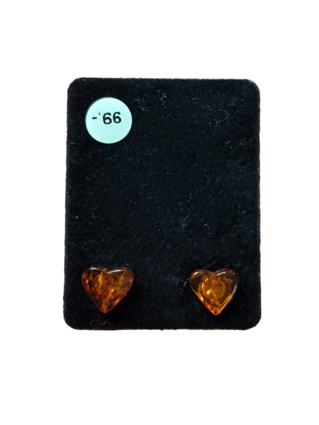 A pair of Heart-Shaped Amber Stud Earrings is displayed on a black card with a white sticker labeled -66.