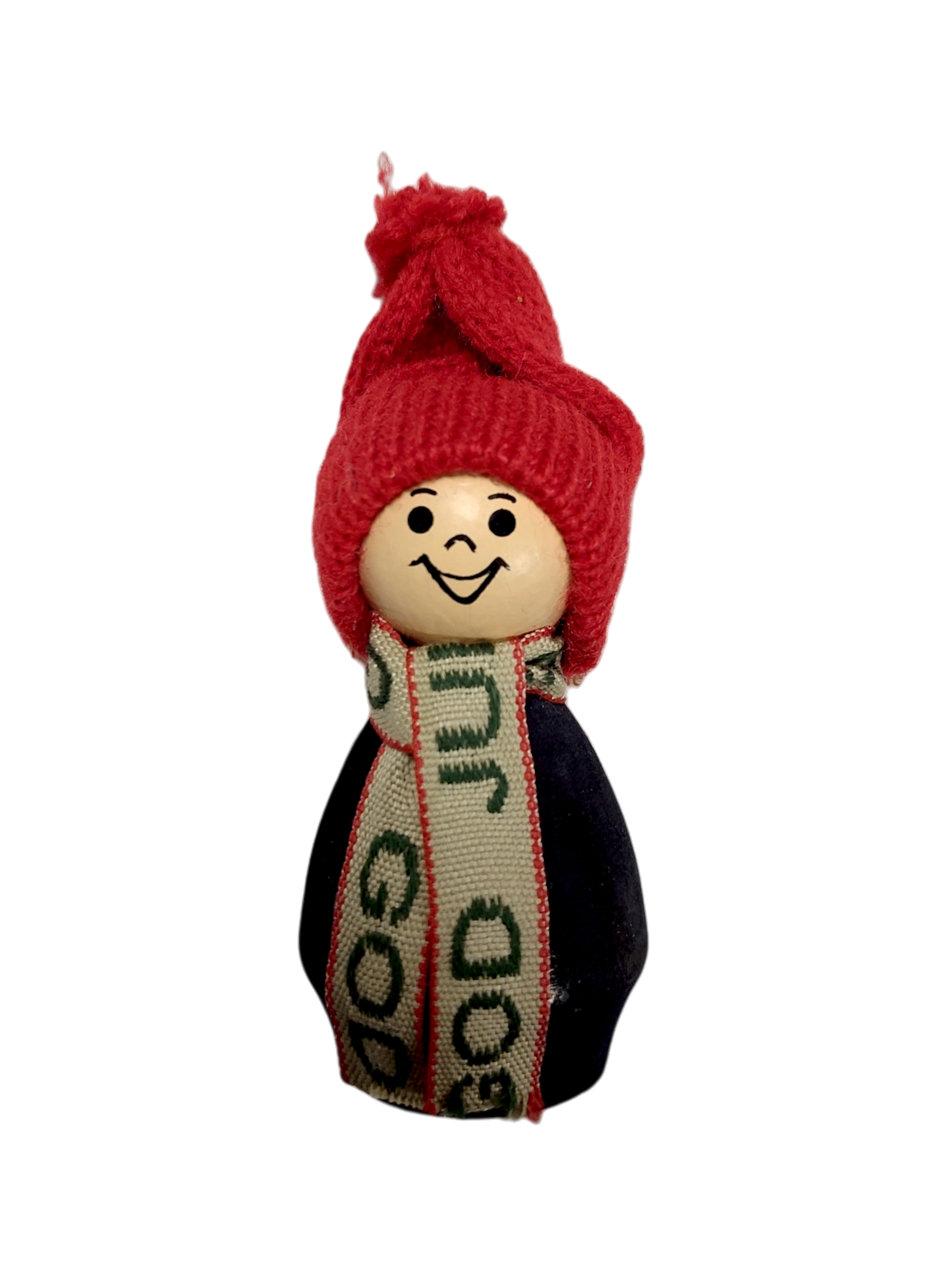 Figurine: Boy in Red Hat Handmade in Sweden—a wooden figurine with a smiling face, red knit hat, and green-scarf accent. This charming Nordic Christmas decoration adds festive cheer, shown against a white background.