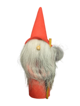 Figurine: Gnome with Tall Red Hat—a small gnome with a long white beard, red hat and body, holding a yellow stick; perfect for giving your holiday décor a whimsical touch.