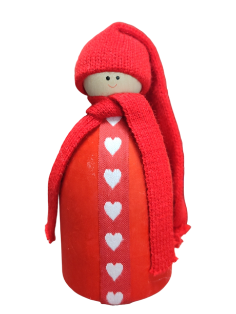 The Santa Figurine with Red Hat features a wooden doll adorned with a red knit hat and scarf and a white heart pattern, adding charming Scandinavian Christmas flair to your holiday table decor.