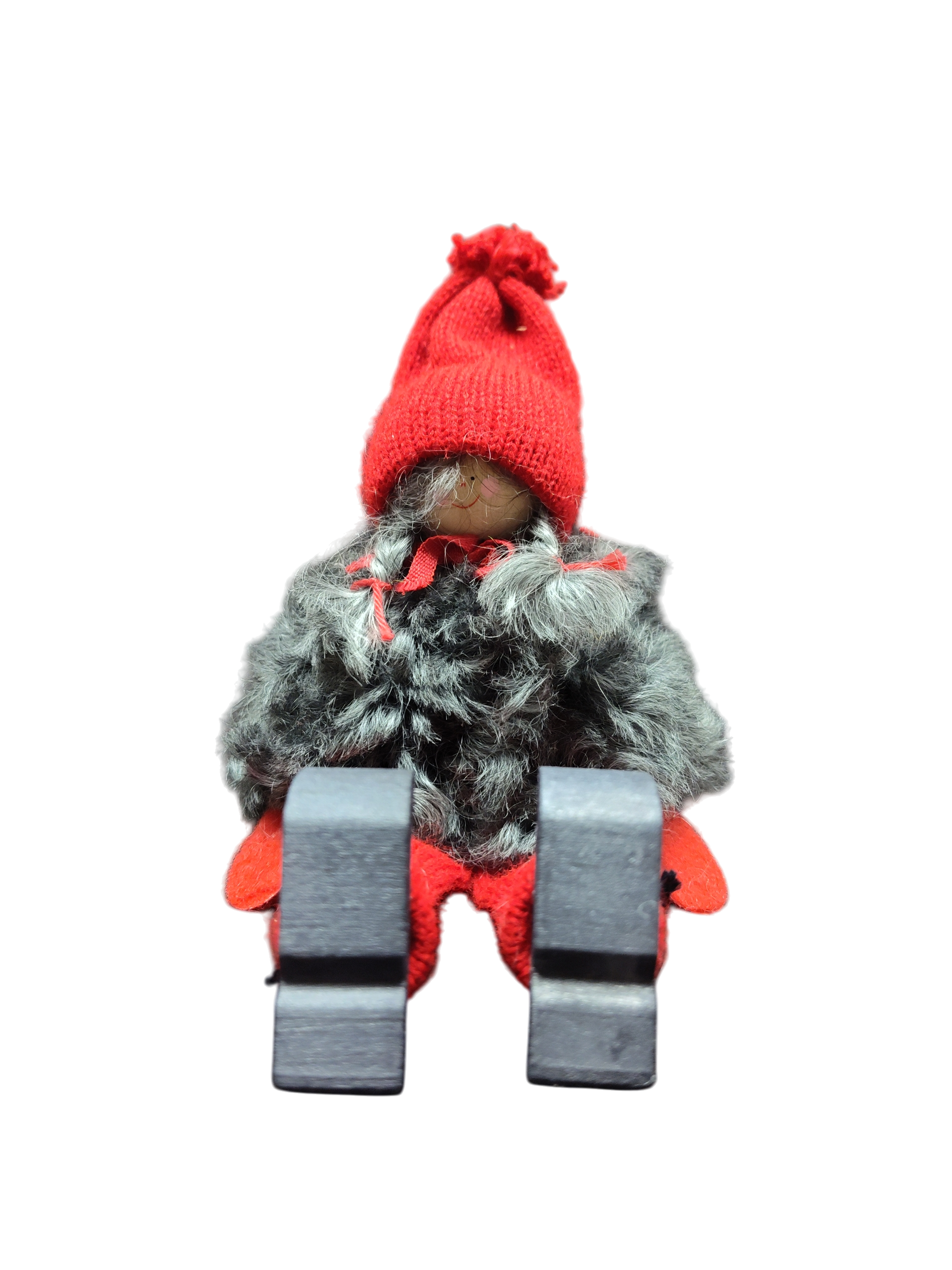 The Sitting Santa Girl Figurine features a red knit hat, mittens, gray faux fur coat, red pants, and black boots. Displayed upright against a white background, it makes a charming addition to your Christmas décor.