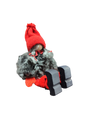 The Sitting Santa Girl Figurine features a red knit hat, red mittens, gray fuzzy coat, and black wooden shoes—handmade in Sweden and perfect as charming Christmas décor.