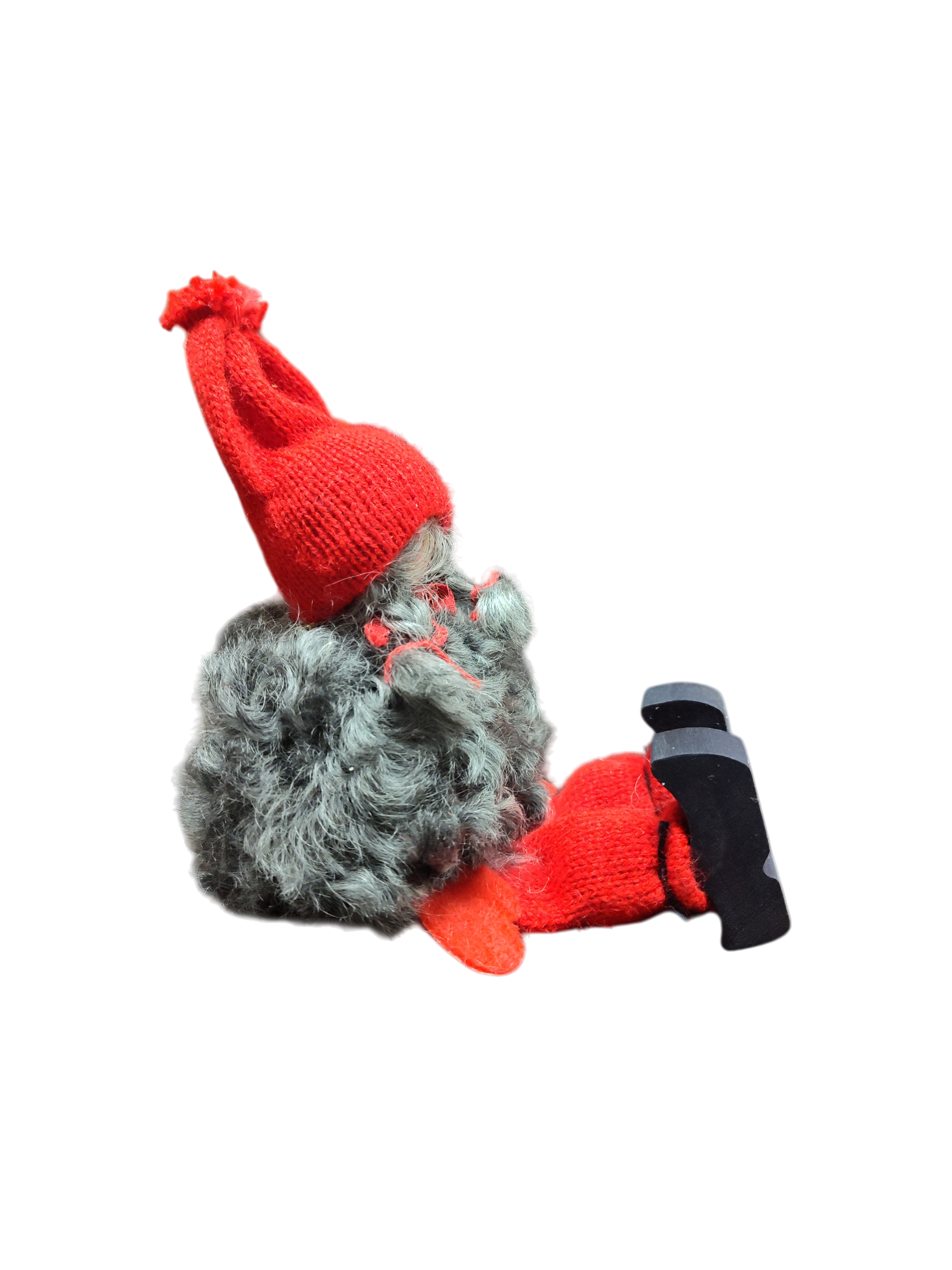 The Sitting Santa Girl Figurine features a plush gnome design with a gray beard, red knit hat, mittens, socks, and black shoes. Handmade in Sweden, it’s a charming Christmas décor piece. Shown side view on white background.