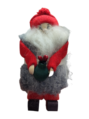 A handmade holiday décor piece, Figurine: Santa with Flower Pot features Santa in red and gray with a green sack holding two red objects, standing upright.