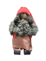 The Santa Figurine 11" is a handmade doll with a curly gray beard, red hat and mittens, striped red and white skirt, and wooden shoes—perfect for holiday decor and standing against a white background.
