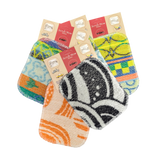 Four vibrant Scrub: Kitchen Scrubber Scrub-Wow pads in assorted patterns and packaging, overlapping on a white background. Safe for Teflon cookware and easy to clean.