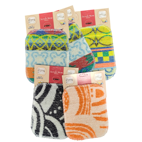Six Scrub: Kitchen Scrubber Scrub-Wow pads in assorted patterns and colors, each with a brown and red label, shown on a white background. These multipurpose pads are safe for Teflon cookware and easy to clean.