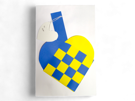 A Card: Swedish Flag Traditional Scandinavian Handwoven Paper Basket Heart with a heart-shaped tag attached by string, shown on a white background.