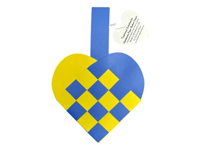 The Card: Swedish Flag Traditional Scandinavian Handwoven Paper Basket Heart features a blue and yellow handwoven heart basket with a handle and a heart-shaped tag displaying printed text.