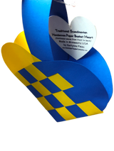 A Scandinavian heart basket in blue and yellow with a woven design, featuring a white heart-shaped tag. Product name: Card: Swedish Flag Traditional Scandinavian Handwoven Paper Basket Heart.