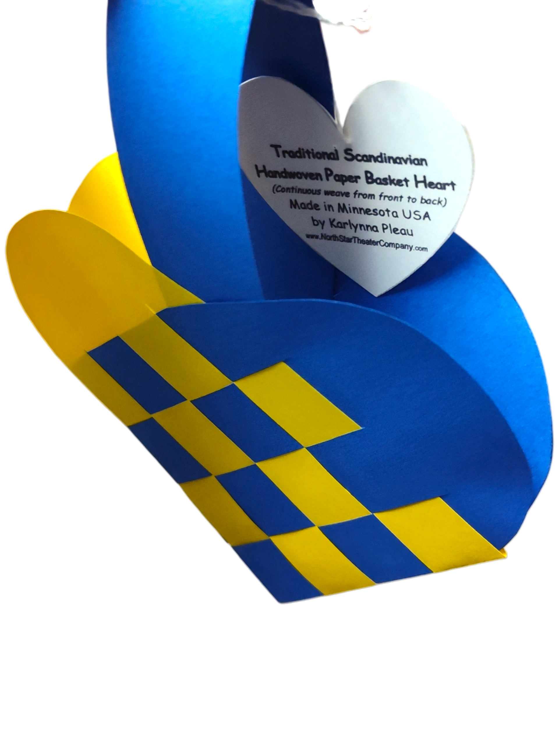 A Scandinavian heart basket in blue and yellow with a woven design, featuring a white heart-shaped tag. Product name: Card: Swedish Flag Traditional Scandinavian Handwoven Paper Basket Heart.