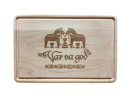 The Cutting Board: Var Sa God Maple Cutting Board (9"x6") features an engraved Scandinavian design and the phrase "Var så god" in script, making it a charming addition to any Scandinavian kitchen decor.