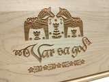 The Var Sa God Maple Cutting Board (9"x6") features two engraved Dala horses, floral designs, and ornate script—ideal as Swedish kitchen decor or unique Scandinavian cutting board art.