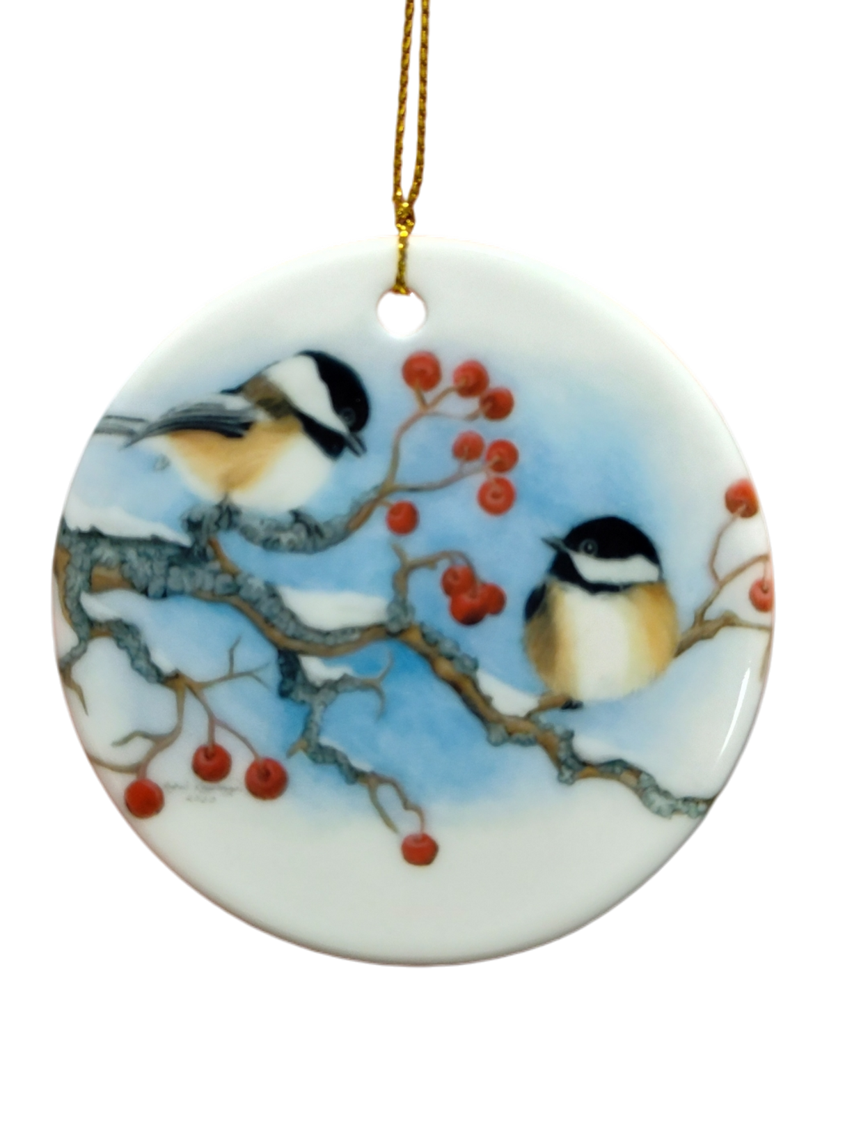 The Ornament: Winter Chickadees Ceramic Ornament features two chickadees on snowy branches with red berries, accented by a gold hanging string—a delightful bird-themed Christmas decoration for your tree.