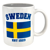 The Swedish Gift Store’s Established Series Sweden Flag Mug (11 oz) displays “SWEDEN” in blue, a yellow and blue flag, and “EST 1523”—a stylish tribute to Sweden’s heritage.
