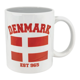 Enjoy your coffee in the Swedish Gift Store’s Mug: Established Series Denmark Flag Mug (11 oz), featuring "DENMARK" above the red and white cross and "EST 965" below, honoring rich Scandinavian heritage.