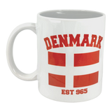 The Swedish Gift Store’s 11 oz Mug: Established Series Denmark Flag Mug features bold red “DENMARK,” two Danish flags with the iconic cross, and “EST 965” below—perfect for celebrating Scandinavian history.