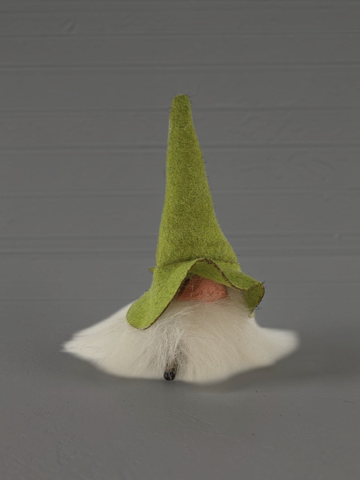 Swedish gnome ornament with a tall green felt hat and long white beard.