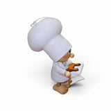 The Faire - Nordic Dreams Tomte Gnome Chef figurine stands 4.75" tall, handcrafted in Scandinavia from wood and wool felt, dressed in white and holding a tray with a crab, facing right on a plain white background.