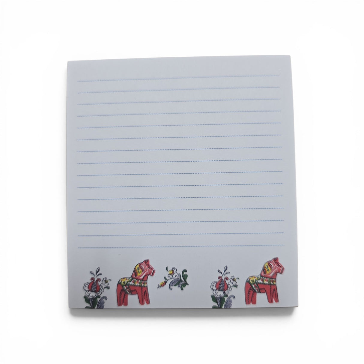 The Swallings Dala Horse Note Pad (3.76"w x 4"h) features blue lines on a white background, with two red Swedish Dala horses and vibrant floral designs at the bottom. Made in Sweden.