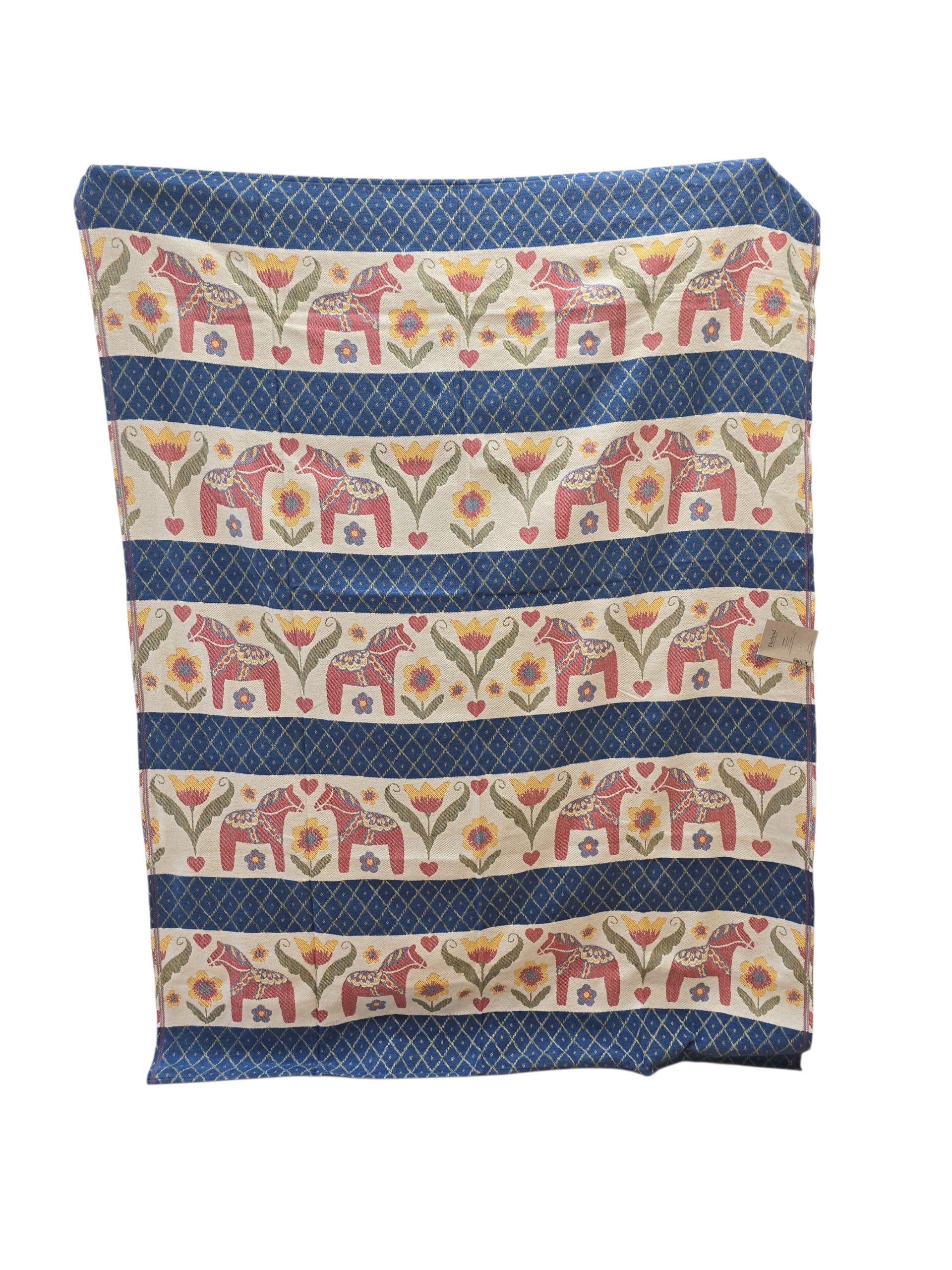 The Dala Horse 100% Cotton Woven Blanket by Ekelund of Sweden (55"x75") features horizontal stripes, playful red horses, yellow floral designs, and a blue geometric border in classic Swedish style.